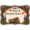 Personalized hand-painted wood sign with truck art and peacock design reading Sana & Ahmed's Home