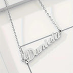 Gold cursive nameplate necklace personalized with custom name
